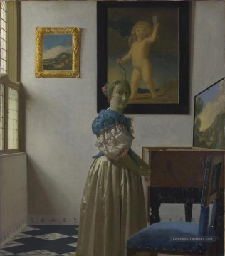 Jeune femme debout dans un baroque virginal Johannes Vermeer Peinture à l'huile